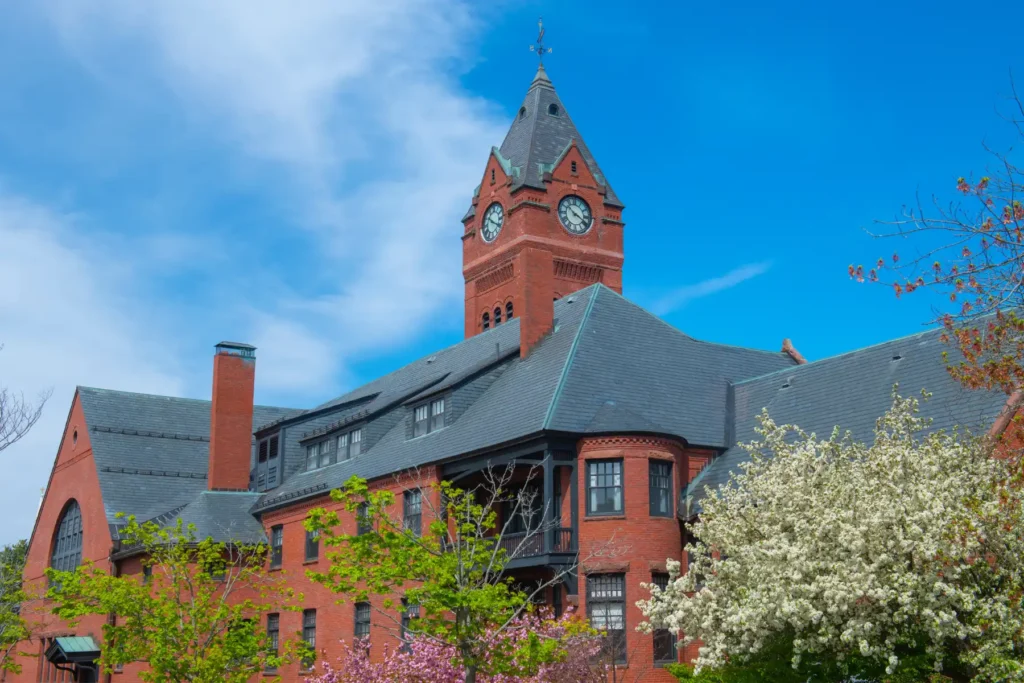 Historic Red Brick Municipal Building with Clock Tower and Spring Blossom Trees.jpg
